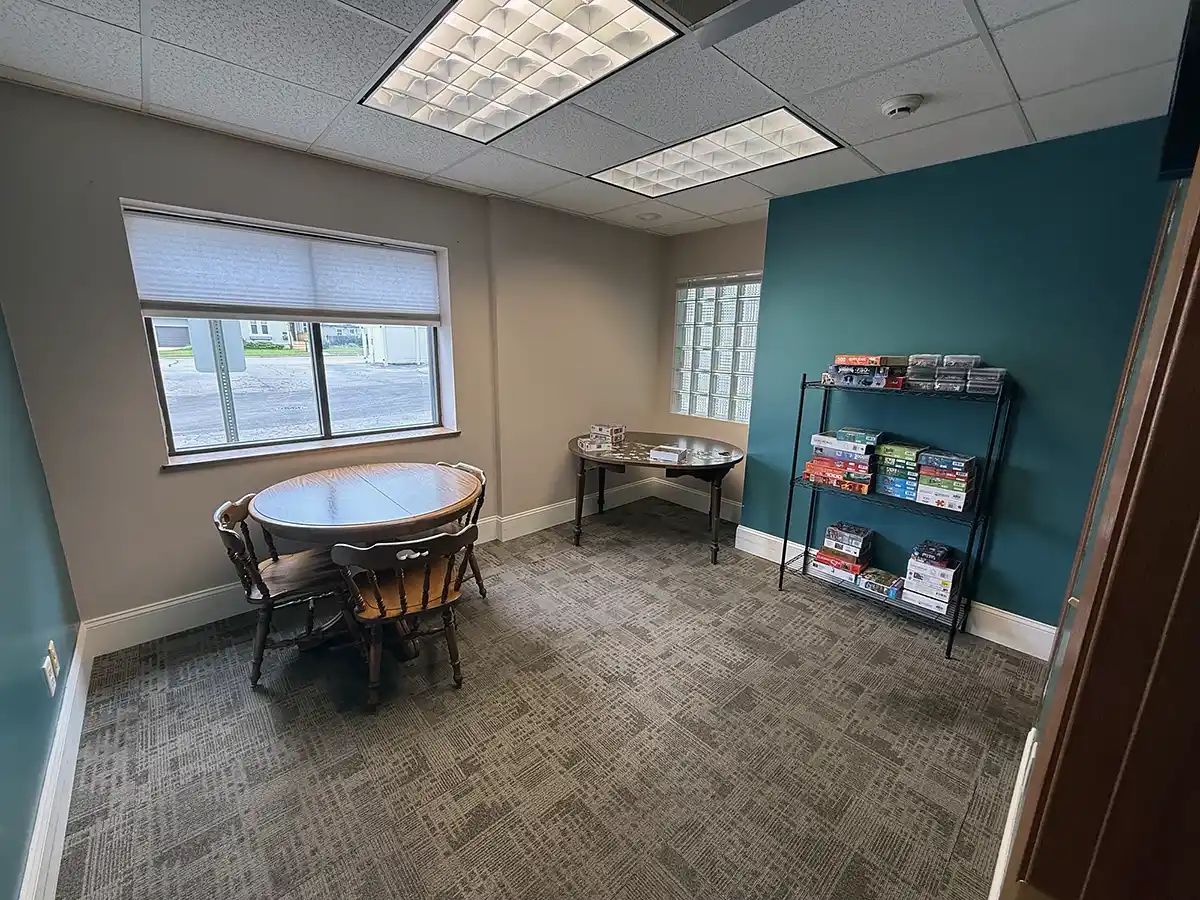 Puzzle room with tables and shelves of puzzles