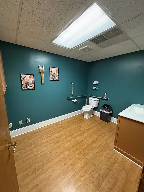 Clean accessible restroom with grab bars